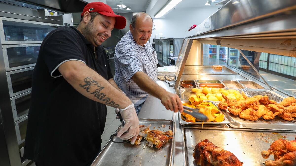 Amit Khanna with Tony Gregoriou from Tony's Chicken Shop in Wollongong. Picture by Adam McLean.