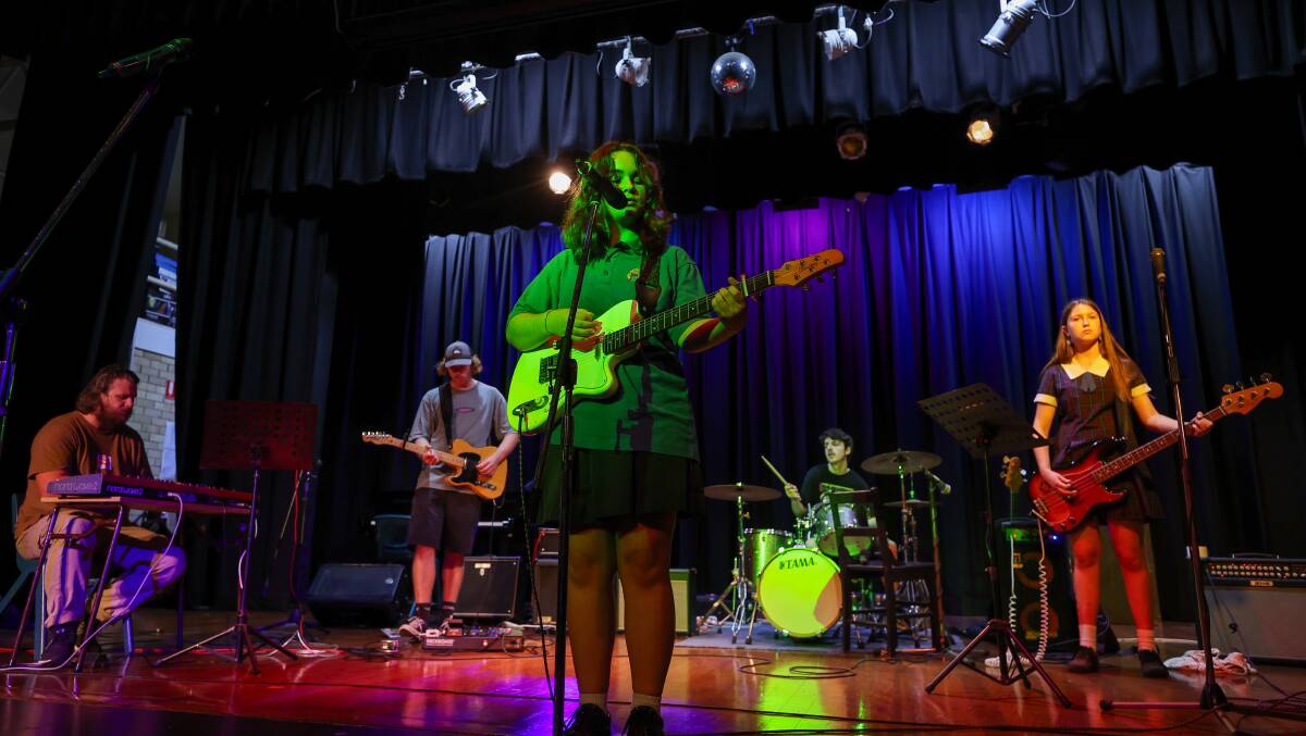 Alara Livingstone at centre-front with Bulli High School students rehearsing for their '80s concert. Picture by Adam McLean