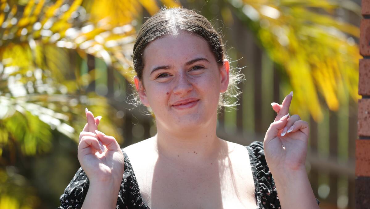 Oak Flats High School graduate Molly Campbell has her fingers crossed as she waits for her ATAR results. Picture by Robert Peet