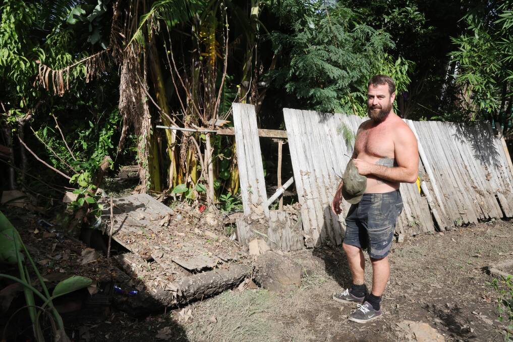 Luke Murray had to break down the fence in his backyard to let the water flow out. Picture by Sylvia Liber