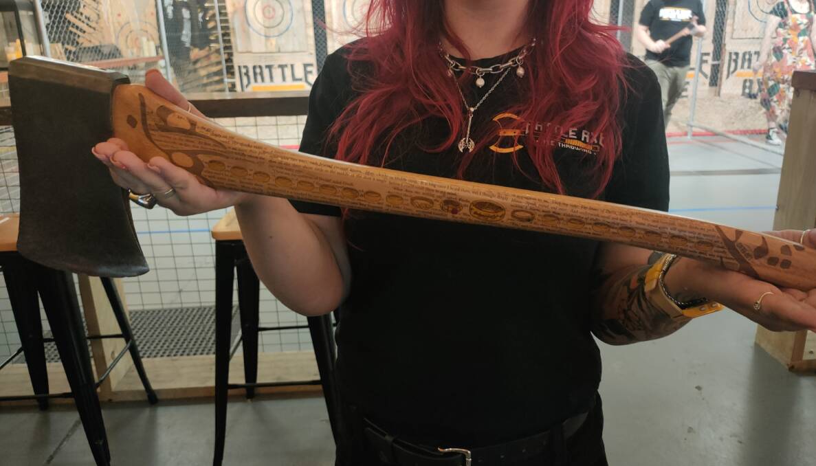 Chloe Lyttle holding the Lord of the Rings etched display axe. Picture supplied
