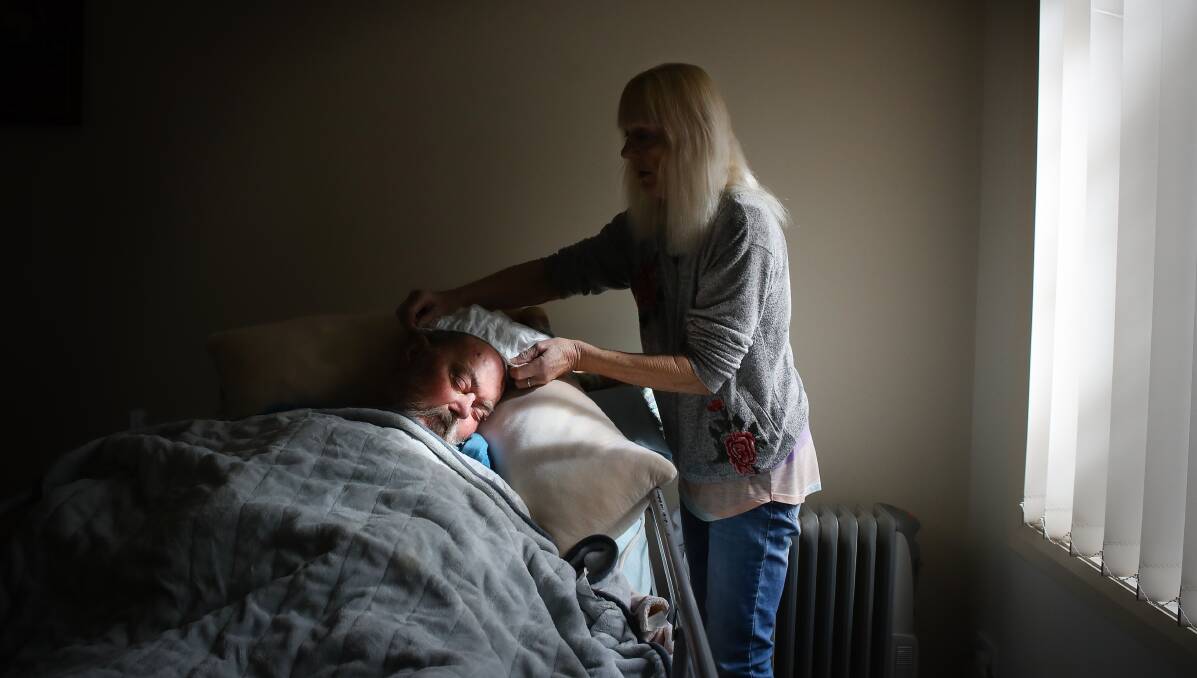 August 8: Woonona woman Susanna Elliott washes her husband Michael's hair at the couple's home. After three surgeries for brain cancer, Michael is completely dependent on Susanna as she cannot get an appropriate aged care package for him. Picture: Adam McLean