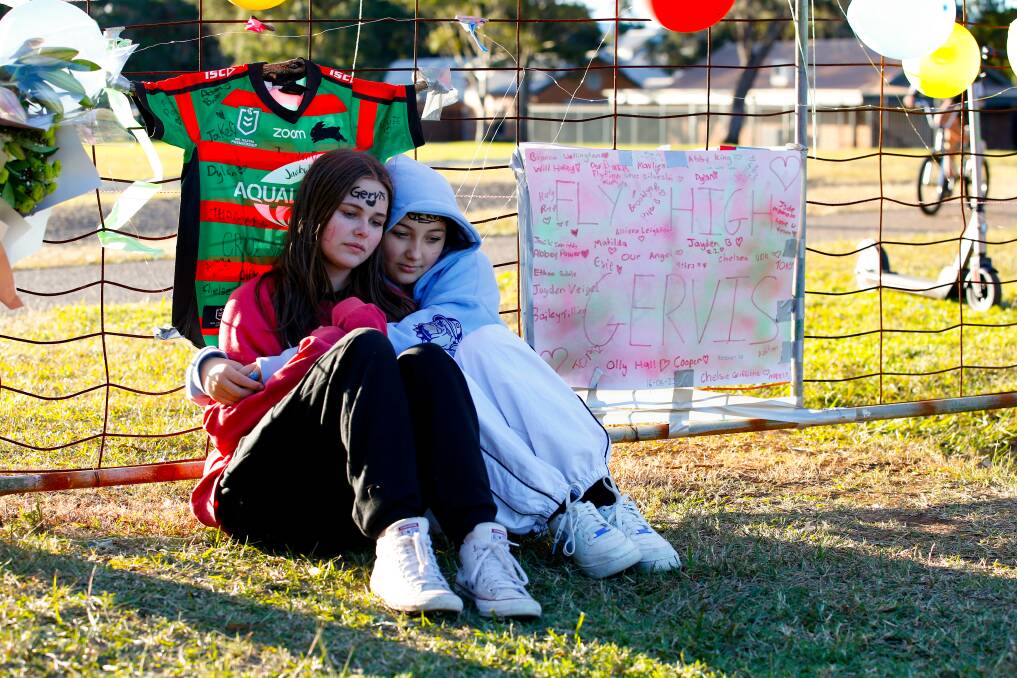 June 18. Keira Kirkup and Marlie Stewart sit at a memorial in Di Gorman Oval in Albion Park for 13-year old Gervis Wililo who crashed into a fence while riding his bike and tragically died. 