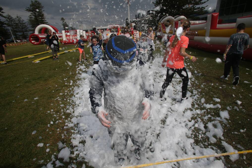 August 25: Logan Mitchell plays at the Obstacool inflatable course in Lang Park in  Wollongong. Picture: Georgia Matts