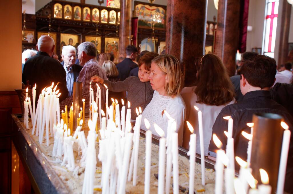 January 7. Church members light of candles at the Orthodox Christmas service at Saint Dimitrija Solunski Macedonian Orthodox Church in Wollongong.