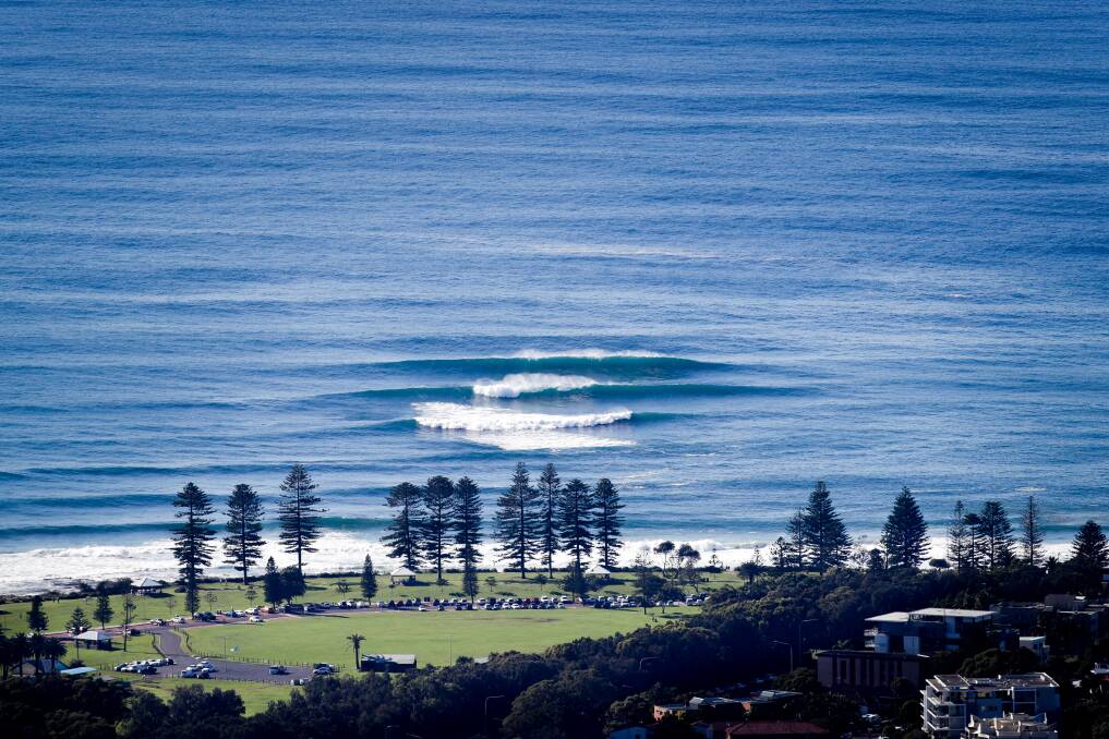 April 17. Large surf breaks on the bombora shelf at North Wollongong beach seen from Mount Keira Lookout. 