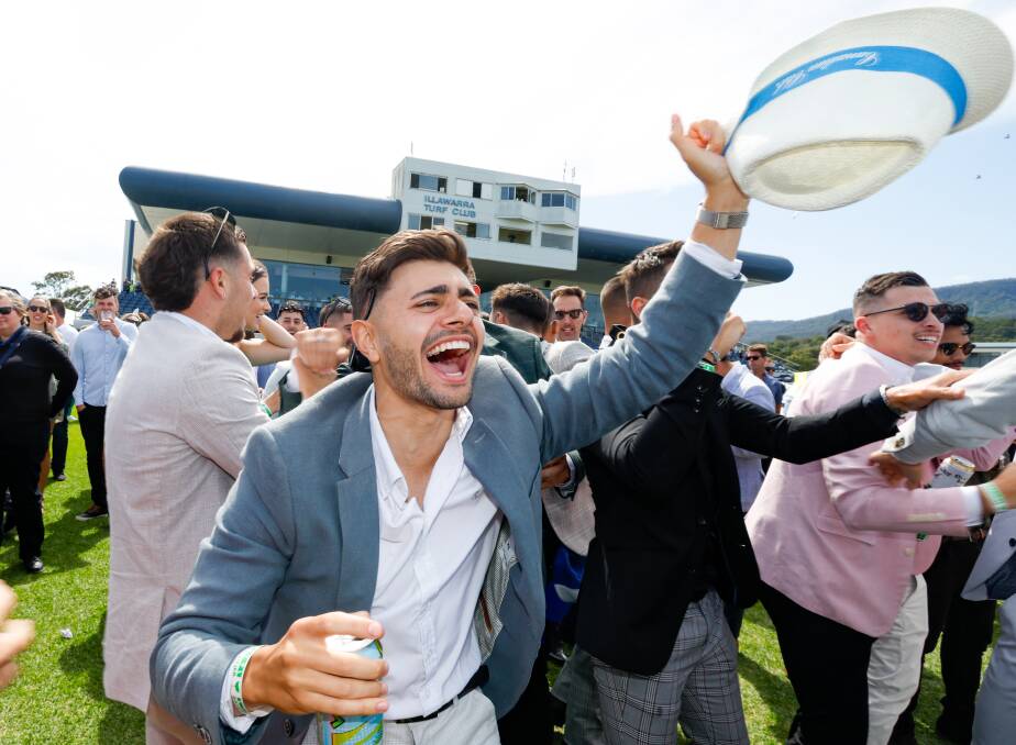November 7. Jason Trevisi celebrates his win in the Melbourne Cup race during the festivities at Kembla Grange Racecourse.