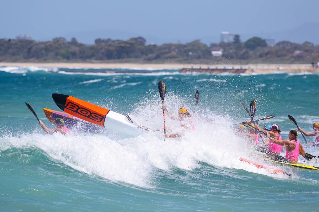November 19. Competitors head out into the surf for the ski leg of the Open Women's Ironman final during the Sydney Water Surf Series / Summer of Surf double header at Bulli Beach. 