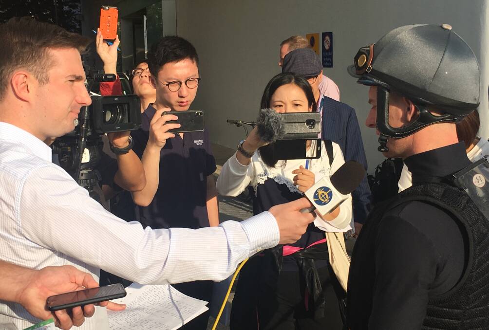 In demand: Zac Purton addresses the media before trackwork at Sha Tin on International Day last December. Picture: Pete Davis