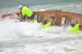 A crew takes a tumble on Day One of the George Bass Marathon 2016. The course has been moved to the Moruya River on January 4 due to heavy rain.