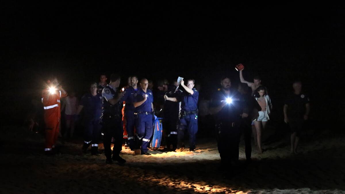 Paramedics treat Brett Connellan at Bombo Beach. Photo: Sylvia Liber