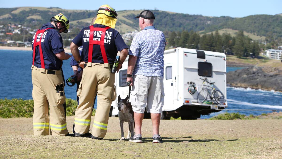A dog was rescued after a motorhome rolled down a hill and onto rocks near Kiama Lighthouse on Tuesday. Picture: Sylvia Liber