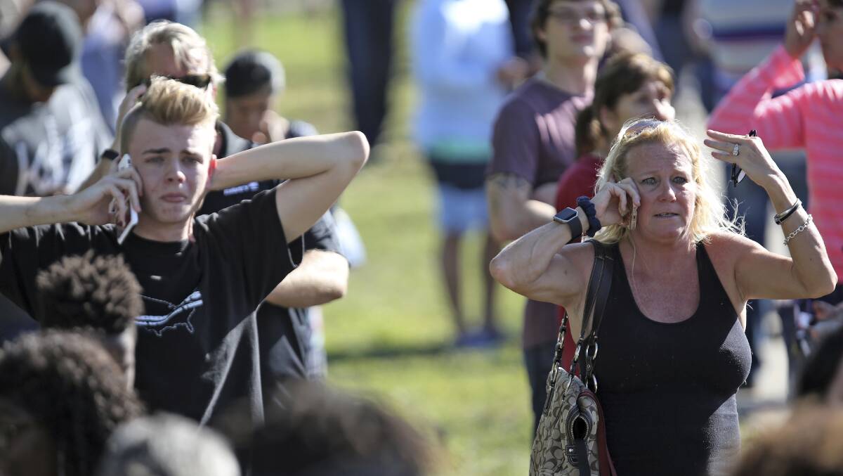 Anxious family members gather at Coral Springs Drive. Picture: AP