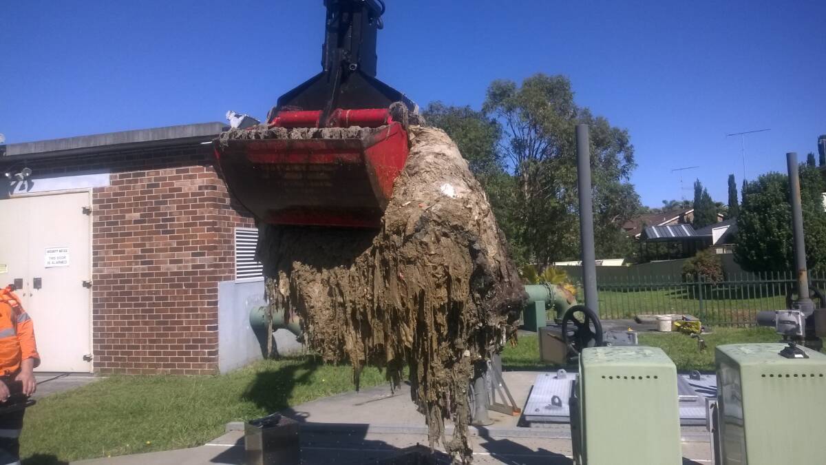 Sydney Water workers at the Shellharbour sewage pumping station cleaning out a blockage of wet wipes also known as a fatberg. Picture: Sydney Water