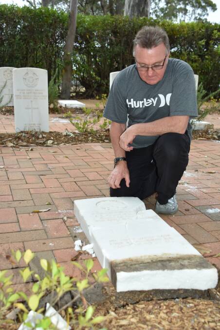 SHATTERED: Veteran and chairman of the Keith Payne VC Veterans Benefit Group, Rick Meehan inspects the damage to one of five graves damaged in the Nowra War Cemetery.