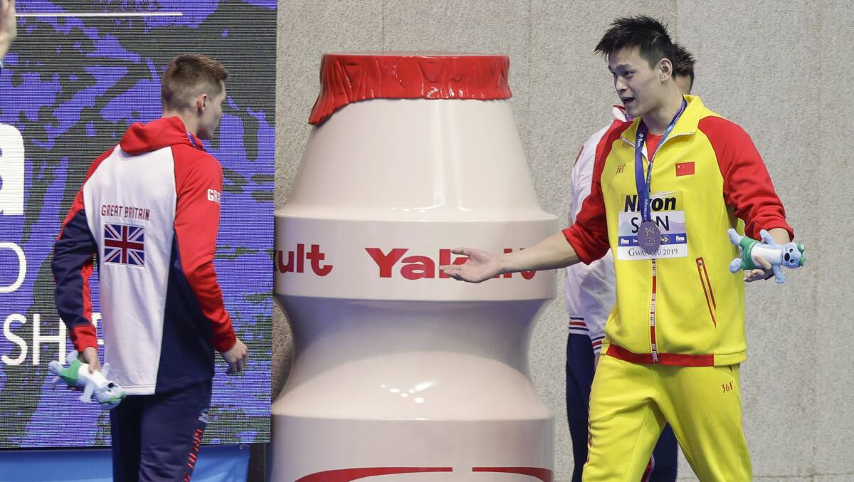 "I win, you lose": Gold medalist China's Sun Yang, right, gestures to Britain's bronze medalist Duncan Scott. Picture: Mark Schiefelbein/AP