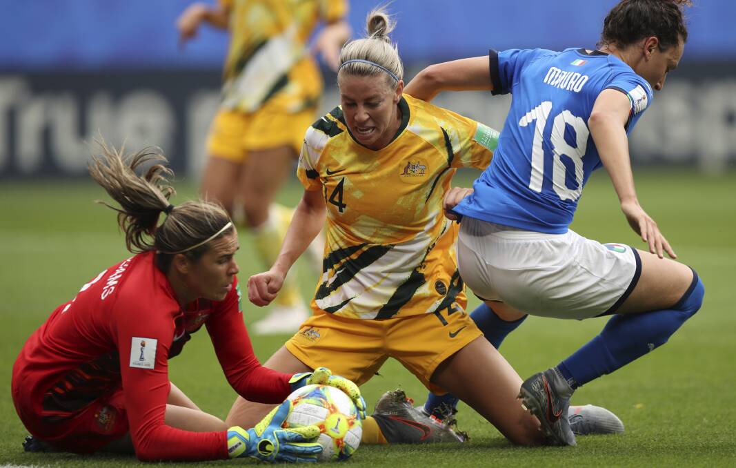 Australia goalkeeper Lydia Williams, left, and Australia's Alanna Kennedy, center, make a save against Italy's Ilaria Mauro. Picture: AP