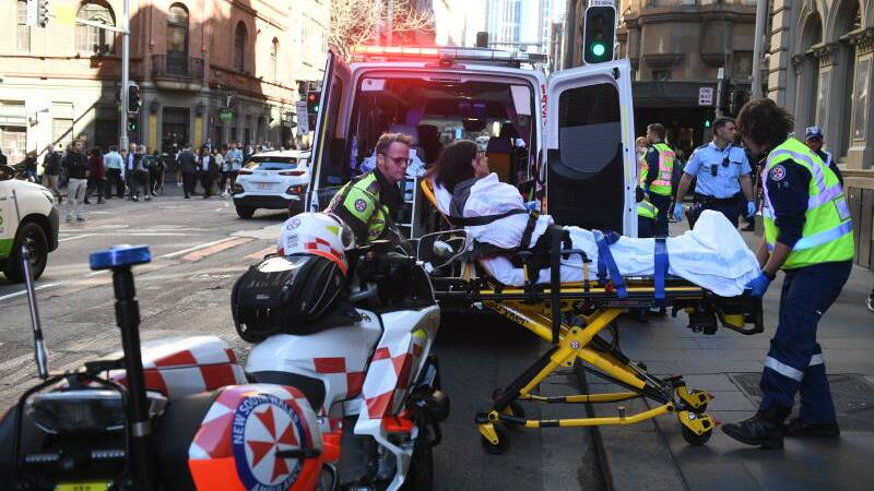 A women is taken by ambulance from Hotel CBD at the corner of King and York Street in Sydney.