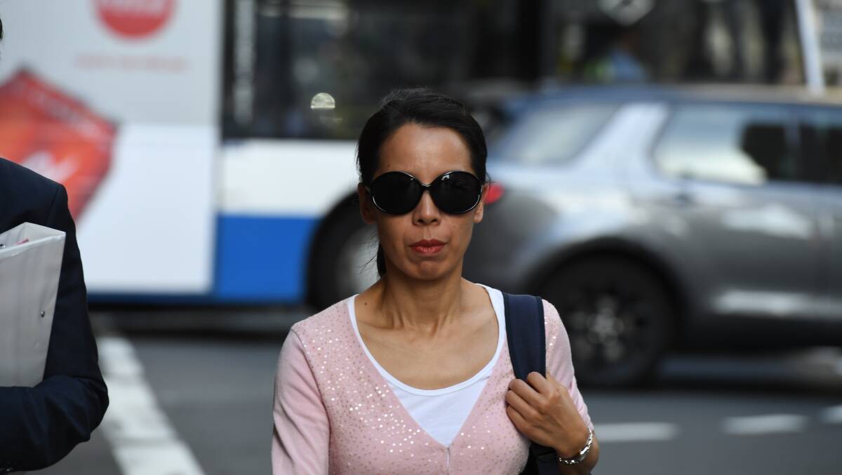 Kathy Lin, the wife of Robert Xie, leaves court on Friday. Photo: Peter Rae