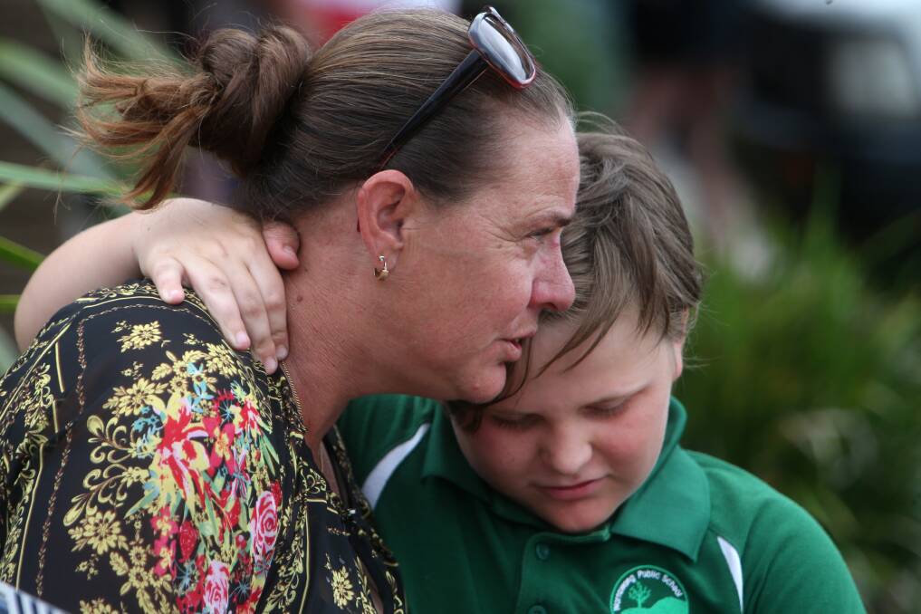 A shaken Vickie O’Donnell is comforted by her 10-year-old son, Daniel Morgan at the crash scene. Picture: Sylvia Liber
