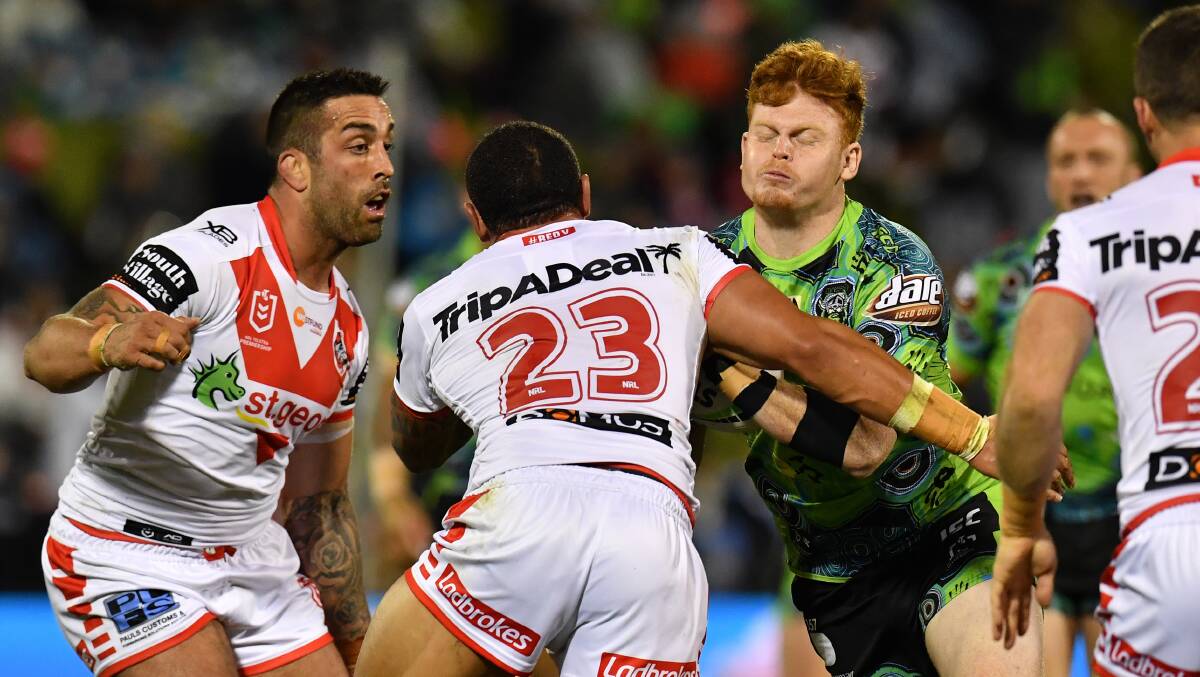 Corey Horsburgh of the Raiders is tackled by Paul Vaughan and Tyson Frizell of the Dragons. Picture: AAP