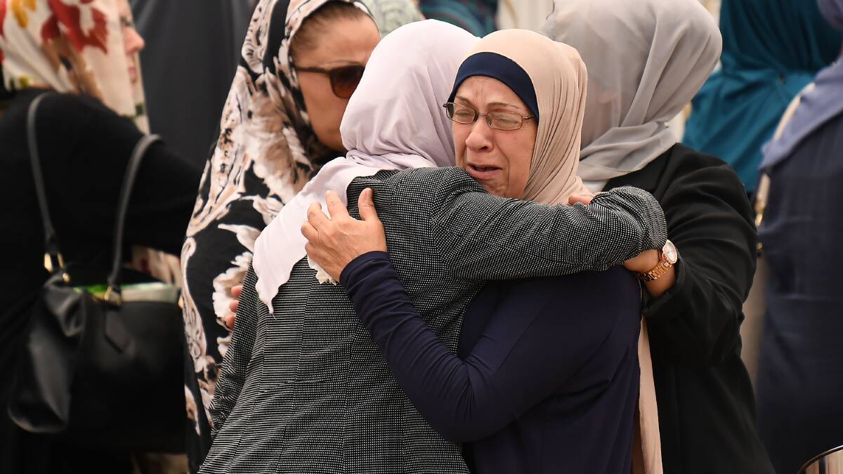 Women embrace before attending the funeral of Banksia Road Public School student Jihad Darwiche at Lakemba Mosque. Photo: David Moir