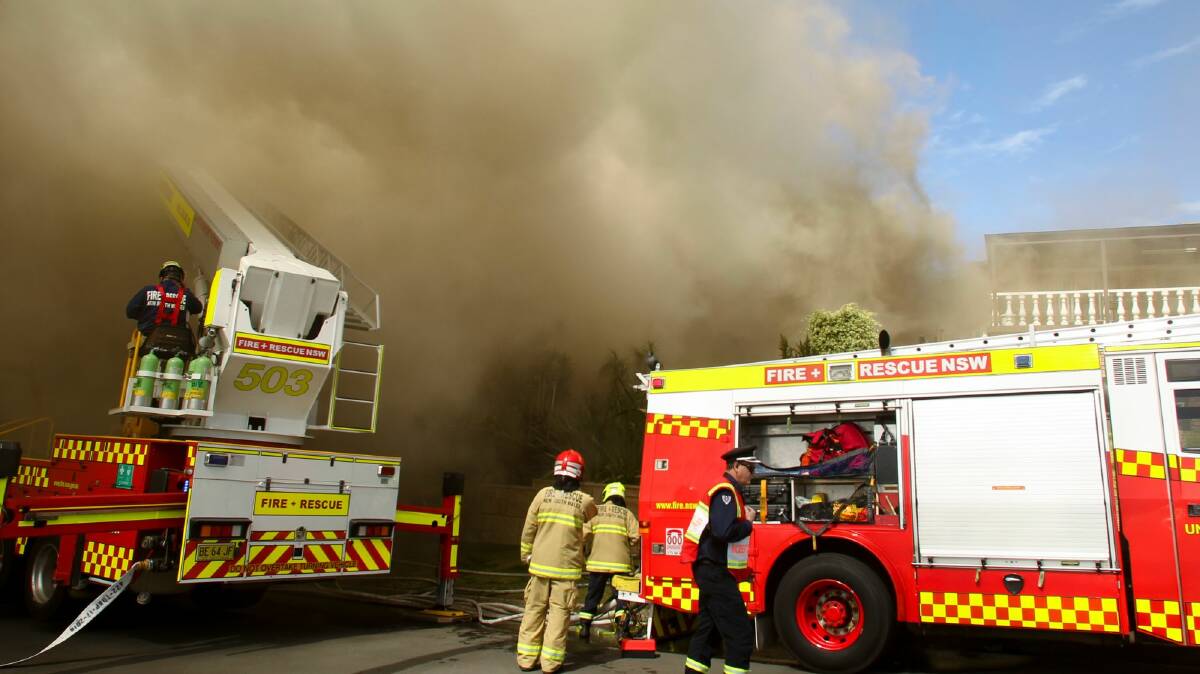 Firefighters battled to control a house fire at Unanderra on Monday. Picture: Anna Warr
