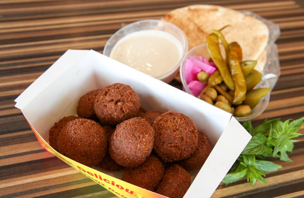 Al Aseel's takeaway falafel comes with pickles, flat bread and tahini. Picture: Adam McLean