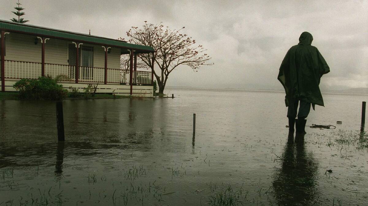 Lake Illawarra Village resident Kerry Daly ponders the damage from the one-in-three-hundred-year flood.