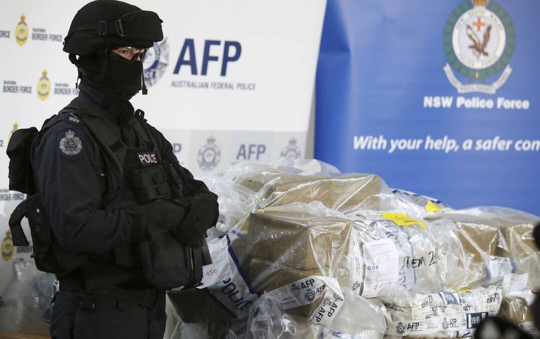 AFP officers stand guard over some of the 500kilo cocaine seized during the Christmas Day bust. Picture: Kate Geraghty