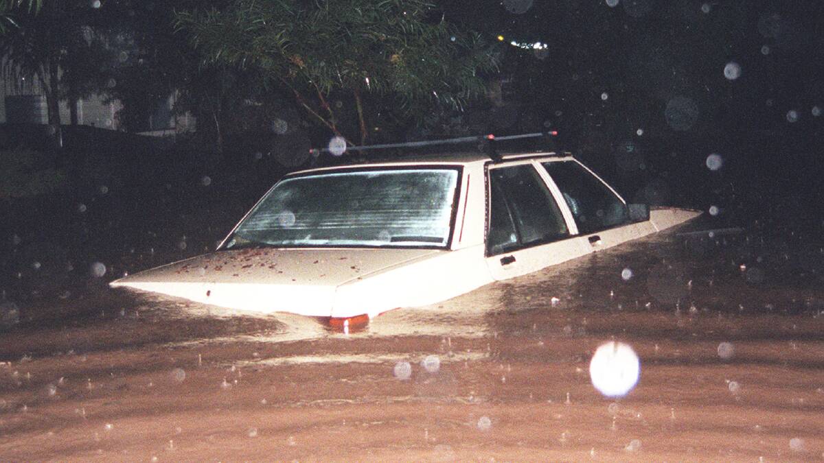 Floodwaters submerge a car at Fairy Meadow. The driver had just jumped clear.  