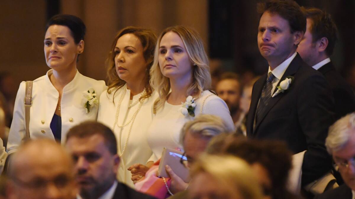 The family of veteran soccer broadcaster Les Murray attend his state funeral at St. Mary's Cathedral in Sydney. Photo: DEAN LEWINS