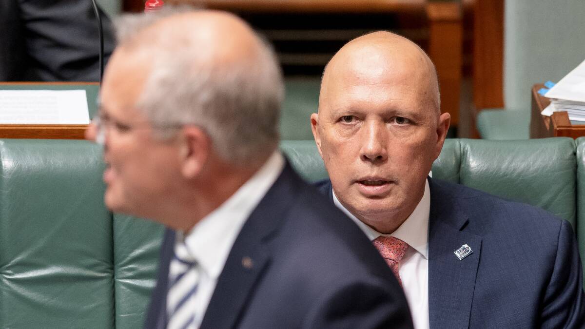 Peter Dutton listens as Prime Minister Scott Morrison addresses the House of Representatives in March 2021. Picture: Sitthixay Ditthavong