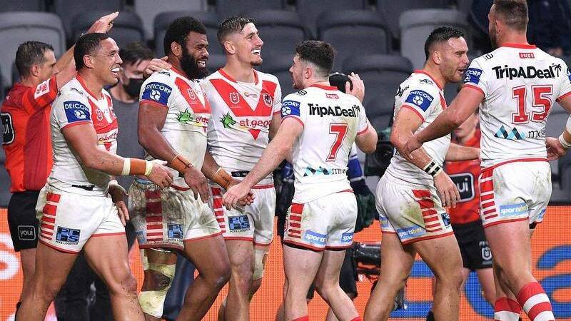 Adam Clune (seven) and his St George Illawarra teammates celebrate a try on Friday night. Photo: Dragons Media