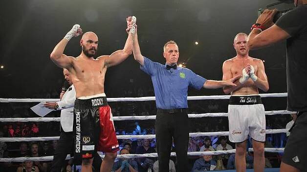 Rocky Jerkic (left) being awarded the fight by referee Les Fear on Friday night against Mark Lucas.