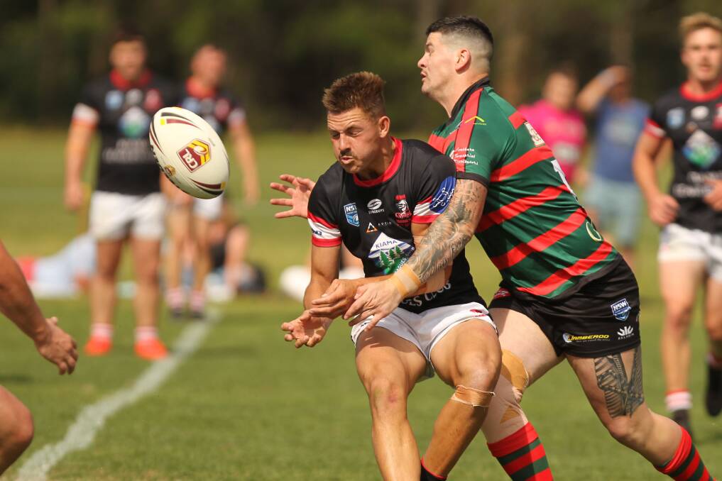 Cam Vazzoler gets a pass away, despite pressure from Jamberoo's Kyle Stone, in what proved to be his last game for Kiama. Photo: David Hall