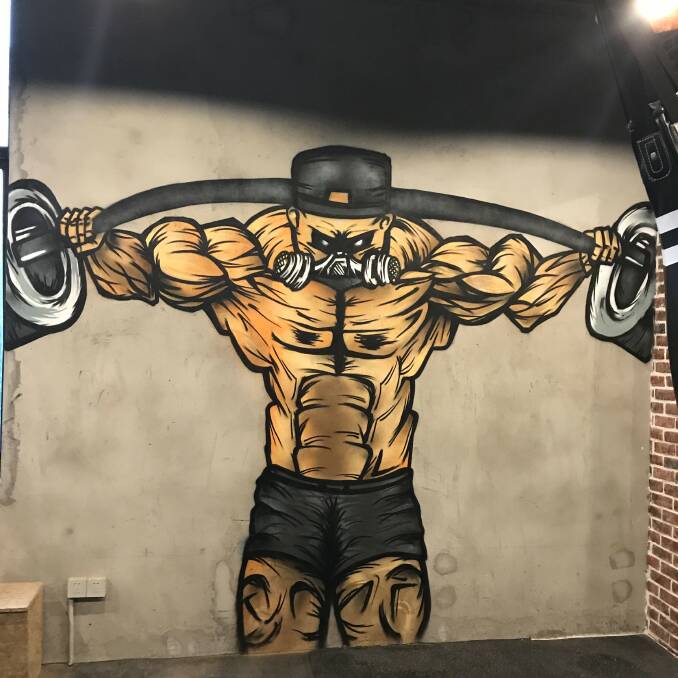 The weight lifted James created on the wall of Love Mirror gym in Shanghai. Picture: Kreamart