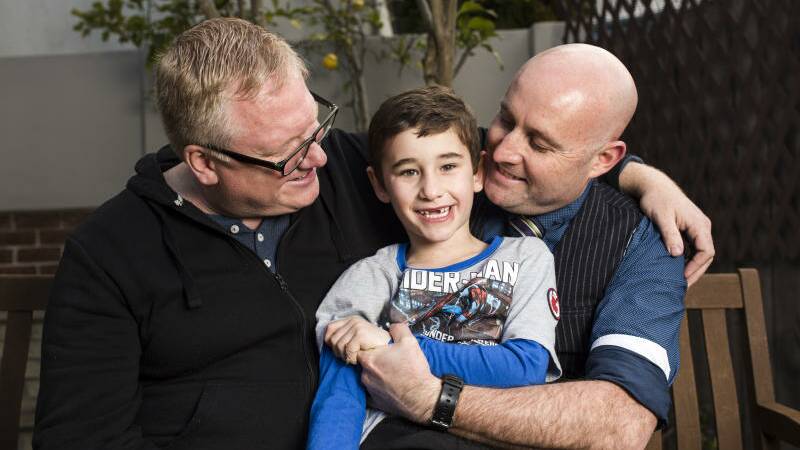 Dale (left) and Jamie Todling (right) have been fostering Maclahy (5) since he was 11-months-old. They are the first same sex [married] couple in Canberra to legally adopt. Photo: Jamila Toderas