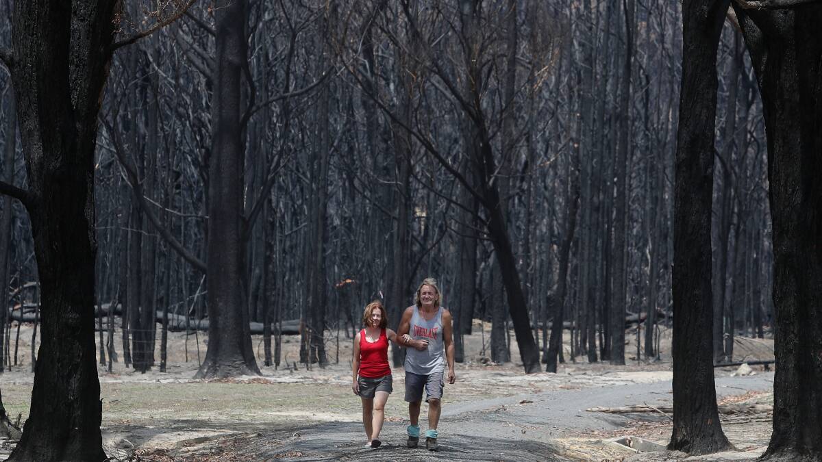 SURVIVORS: Brigid and Andy Jordan on their property, Runfree, on Duffys Lane. They prepared well, physically and mentally, and stayed to fight the blaze. Photo: Robert Peet
