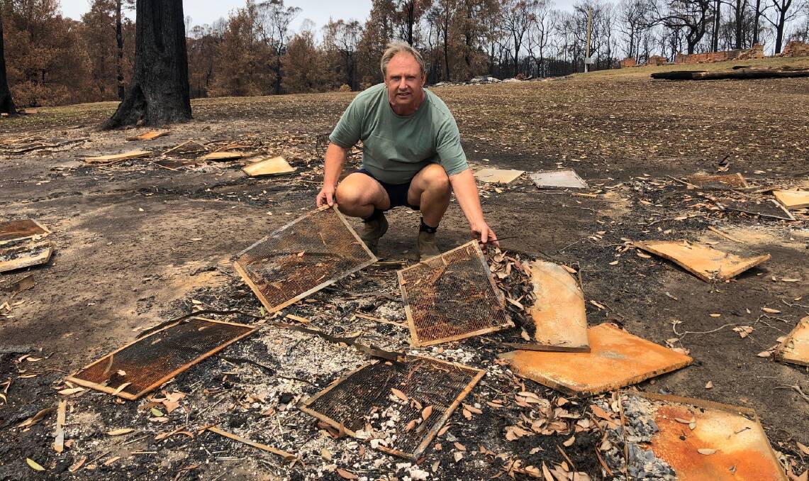 SOUR TASTE: Vince Ingold with some of the hives, along with $10,000 worth of honey and millions of bees, lost to the fire. 