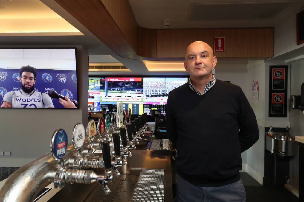 Cheers: Paddy Coughlan behind the bar at Five Islands Hotel, the pub he bought for $20 million as CEO of an investment group earlier this year. Picture: Robert Peet