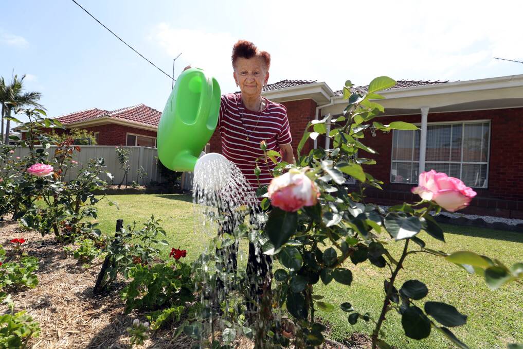 Water restrictions may have eased, allowing hoses in the garden, but Elizabeth Commisso still prefers the watering can. Picture: Robert Peet
