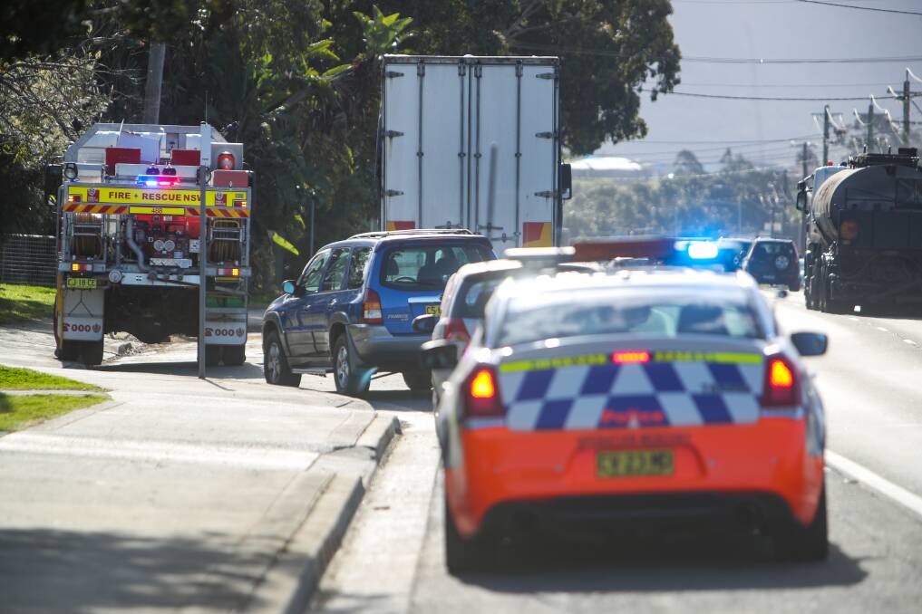 Fire and Rescue NSW crews at the site of an oil spill on the Princes Highway at Albion Park Rail just north of the Mallee Street intersection. Picture: Adam McLean