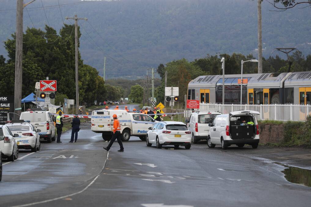 The scene at the West Dapto level crossing, where a train derailed after hitting a car parked on the tracks. Picture: Robert Peet