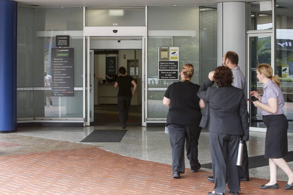 Staff outside Wollongong's Centrelink office in Burelli Street after a man poured petrol on the carpet. Picture: Anna Warr