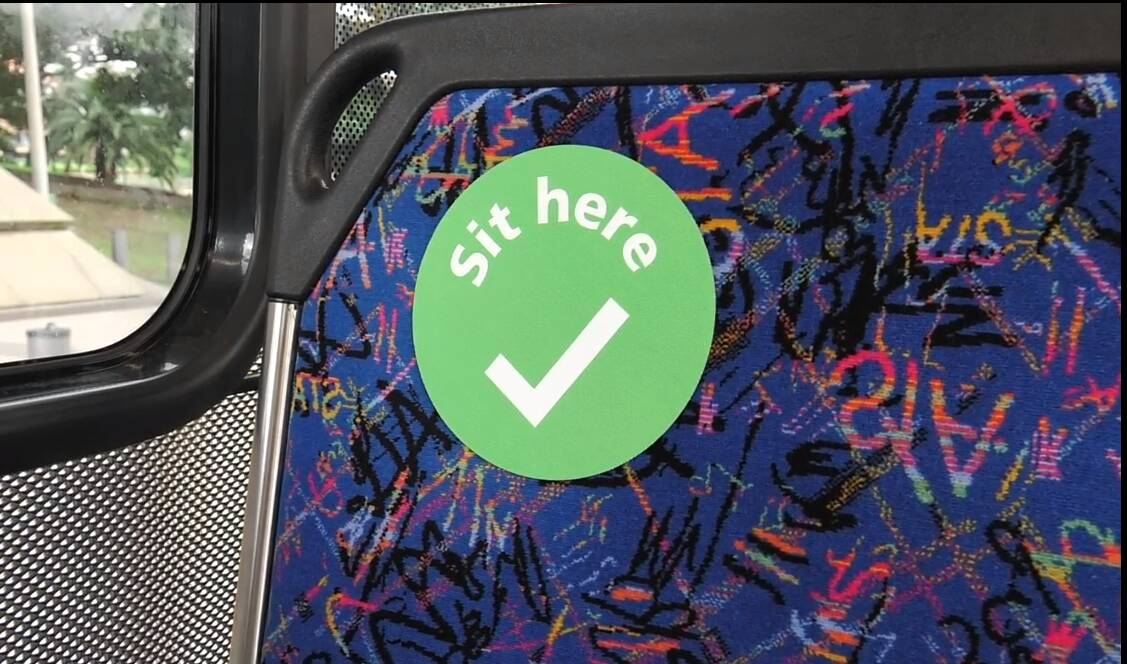 Signs: Throughout the week these green stickers will appear on Illawarra buses and trains to help with social distancing on public transport. Picture: supplied