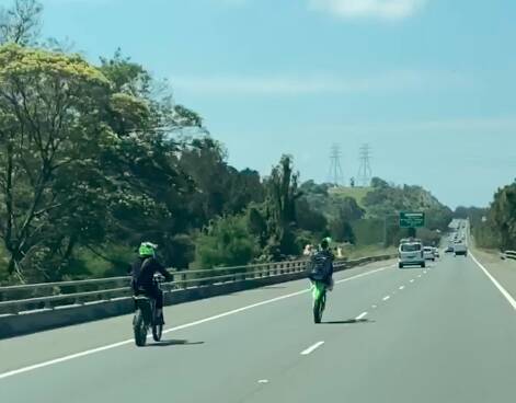 Dangerous: A trail bike rider doing a wheelie on the Princes Motorway, while breaking the speed limit and not wearing a helmet. Picture: supplied