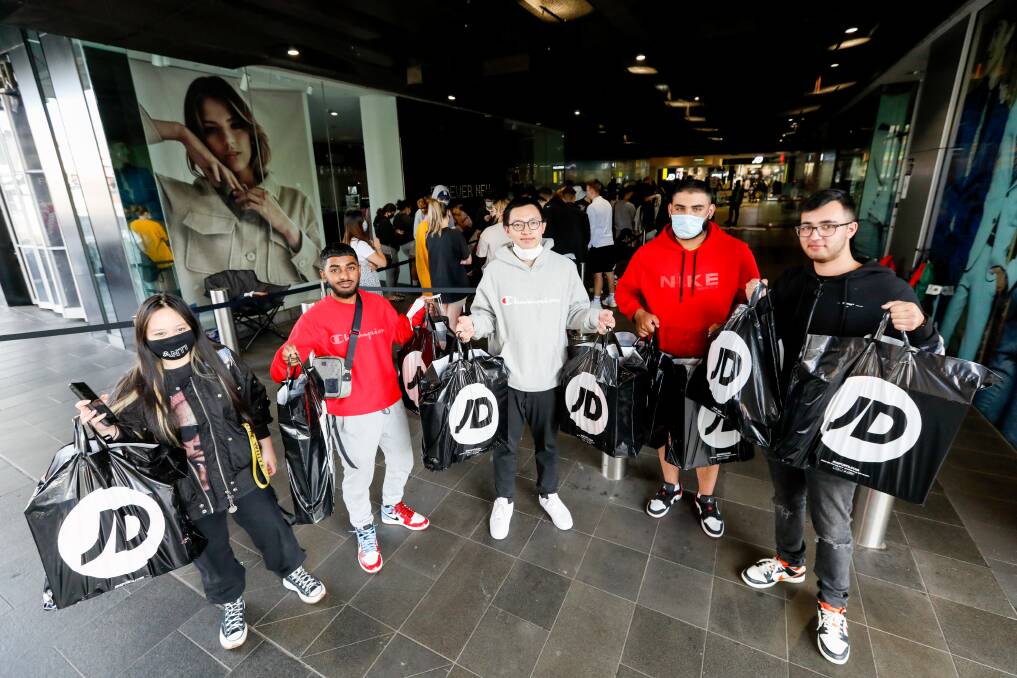 Some of the shoppers who were at the front of the queue to get into JD Sports when it opened in Wollongong Central on Thursday morning. Picture: Anna Warr