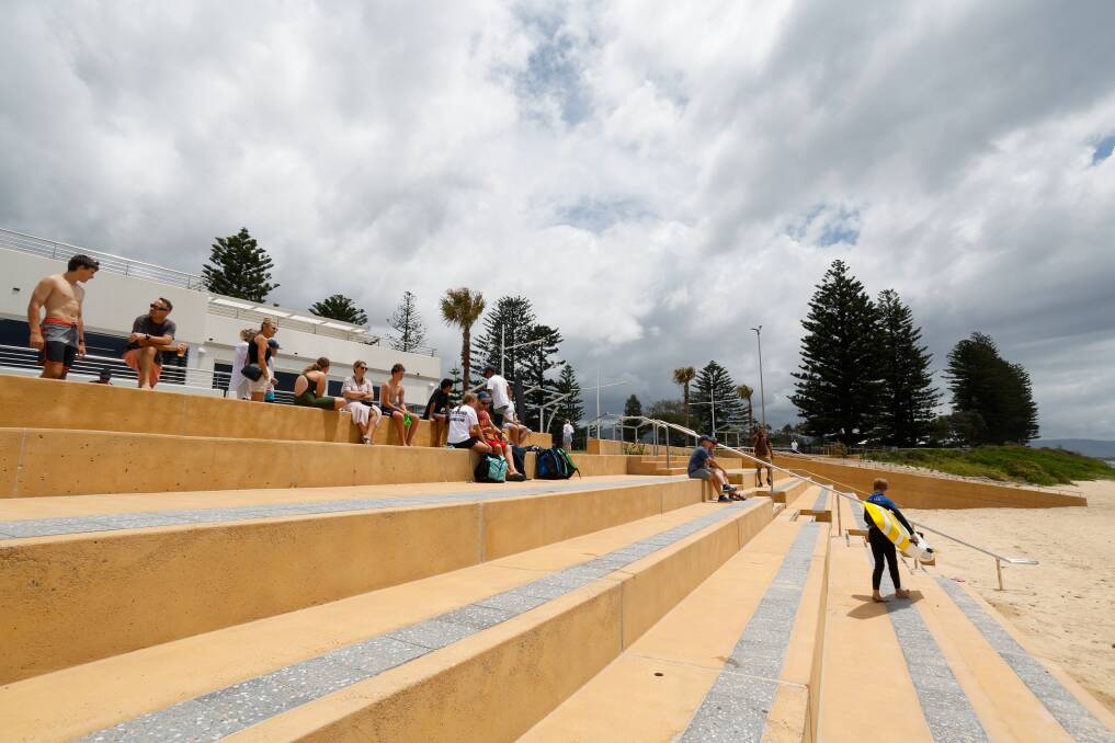 Beachgoers take advantage of the tiered seating on the North Wollongong Beach seawall, just days after it was quietly opened. Picture by Anna Warr