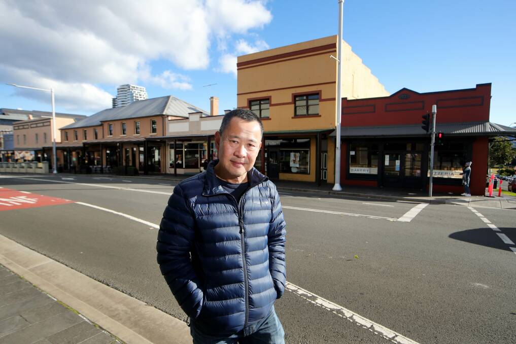 Changes: Les Dion in front of the family-owned restaurant strip on Keira Street ... council has decided to rethink plans to place the buildings on its heritage list. Picture: Sylvia Liber. 